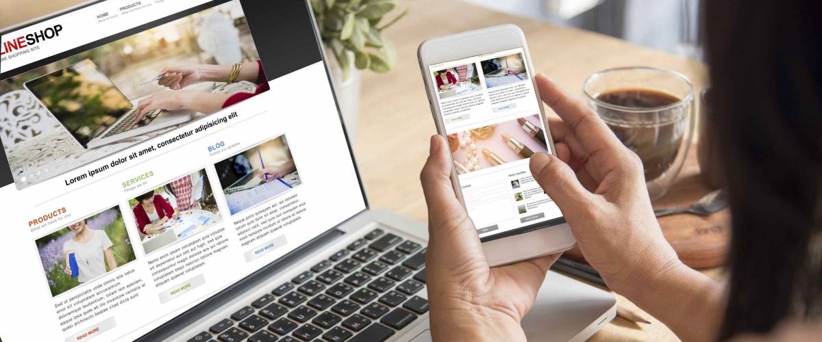 Woman shops online, using both her laptop and her smartphone