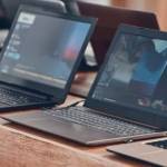 Row of laptops available to buy at a retail store.