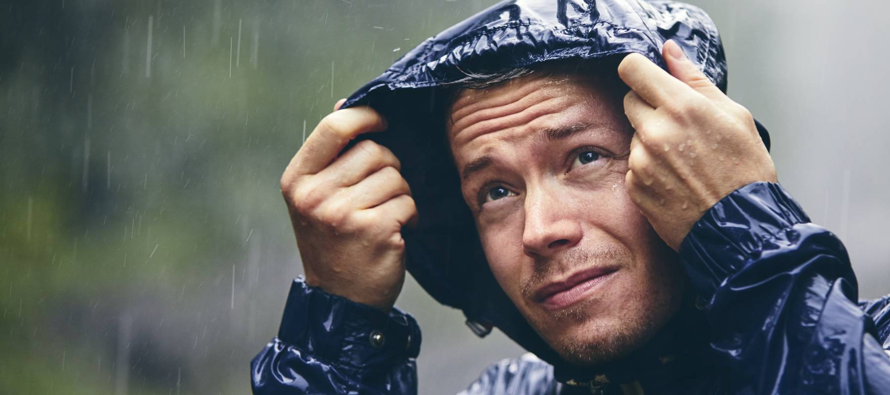 A man walks in heavy rainfall.