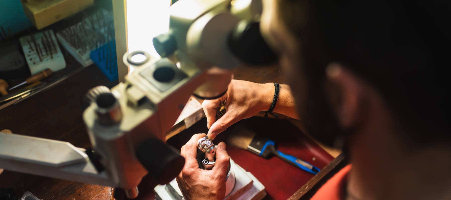 Jeweller inspecting a diamond ring.