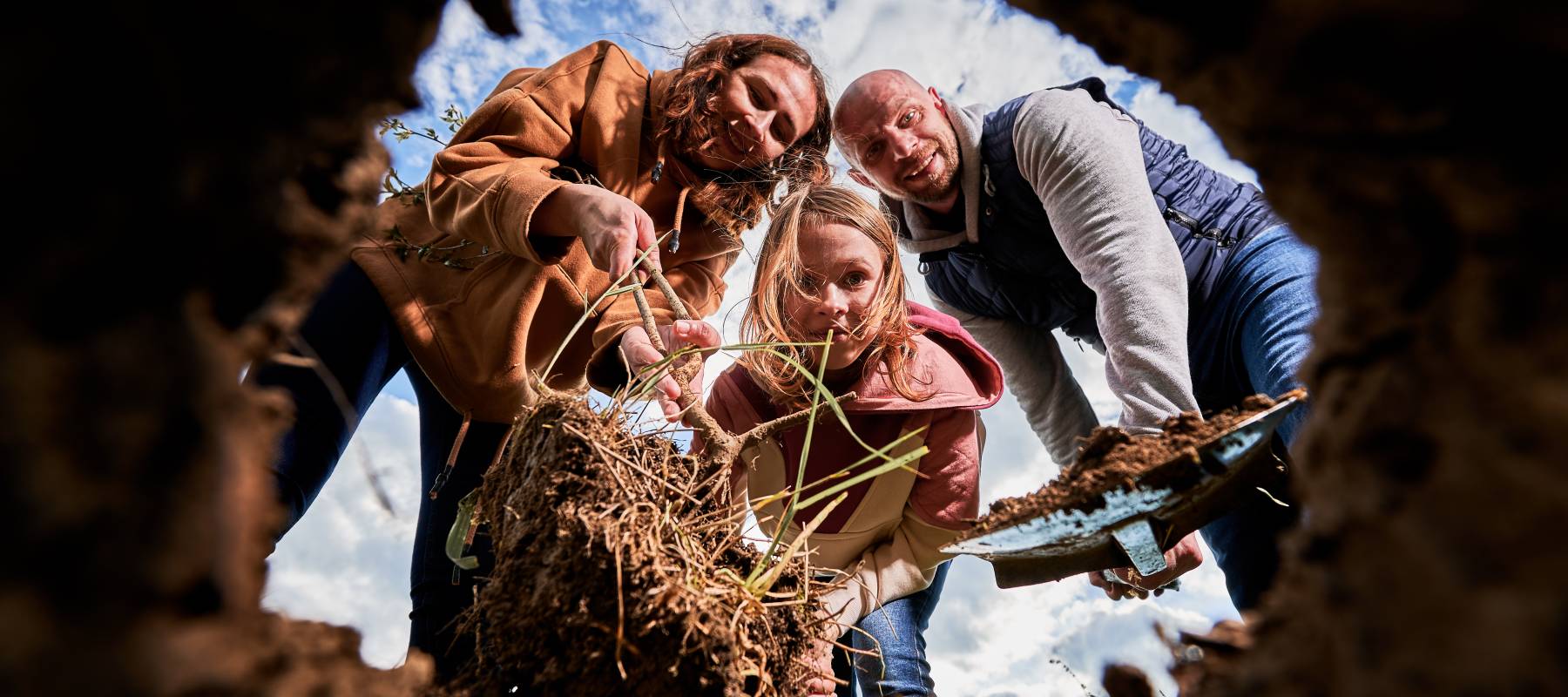 A family digging a hole.