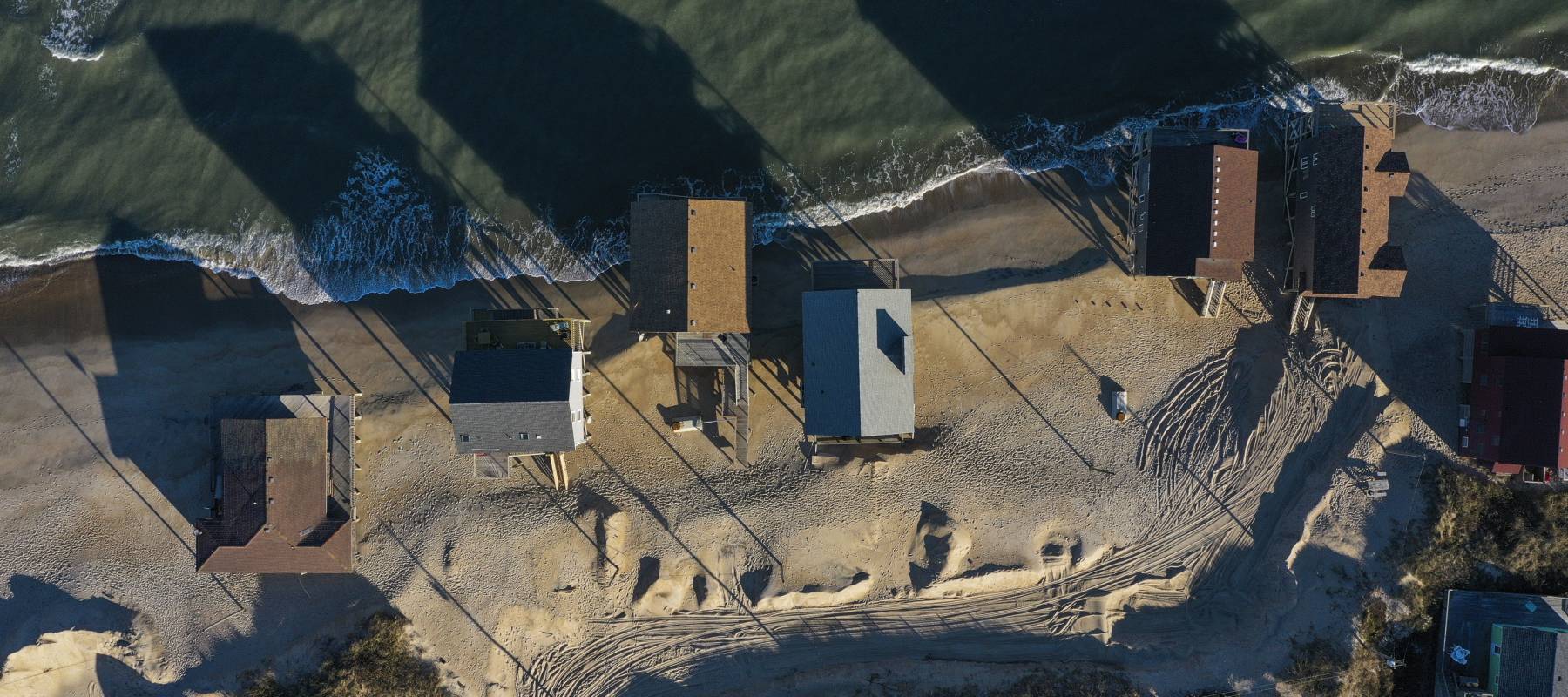 Nine homes have collapsed in North Carolina this week, claimed by years of erosion and the pounding surf fueled by hurricanes Humberto and Imelda.