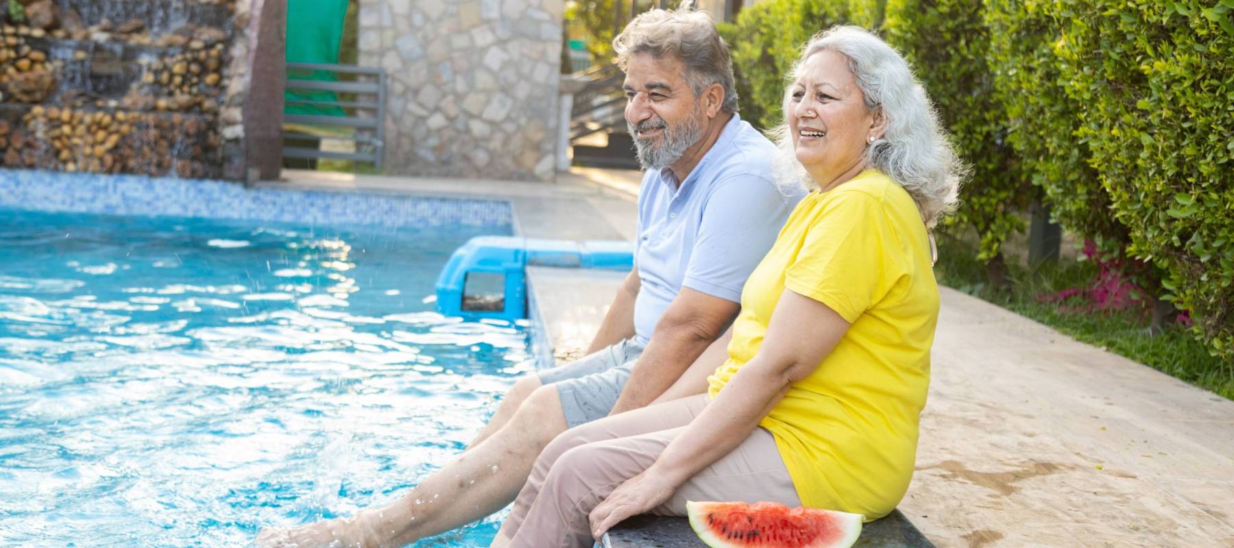 older indian couple by the pool
