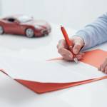 Woman signing car loan