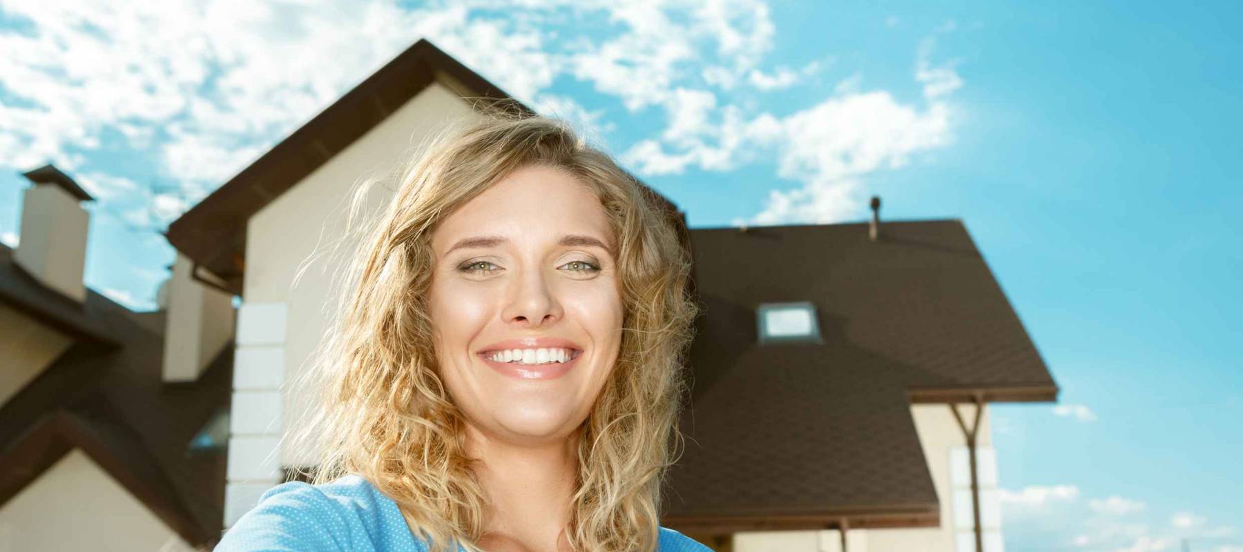 Happy girl taking selfie of her new house