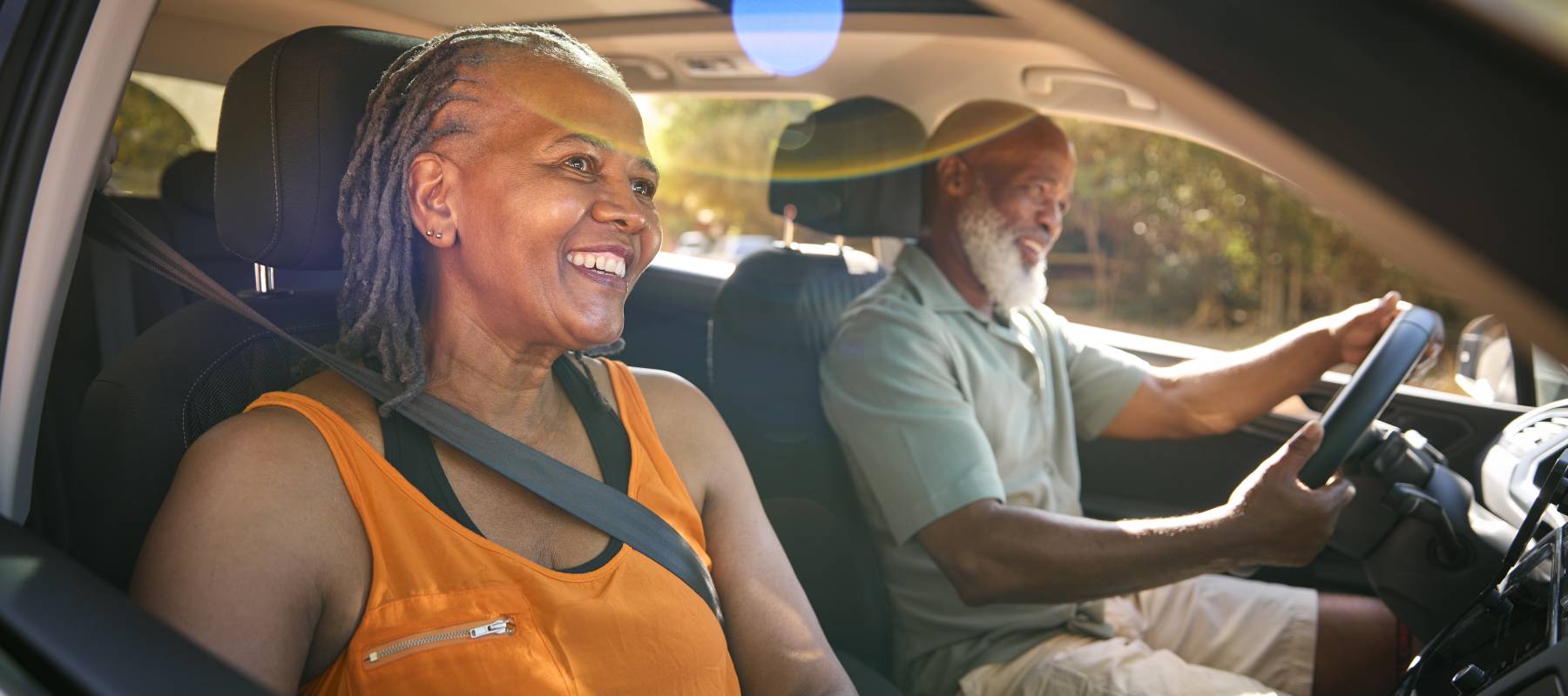 older couple driving in car