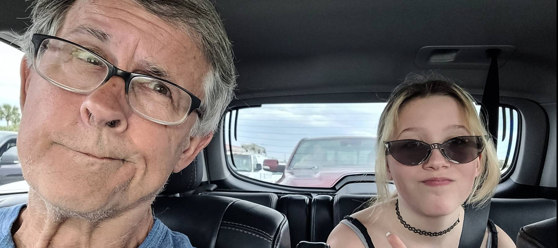 Father and daughter driving in a car.
