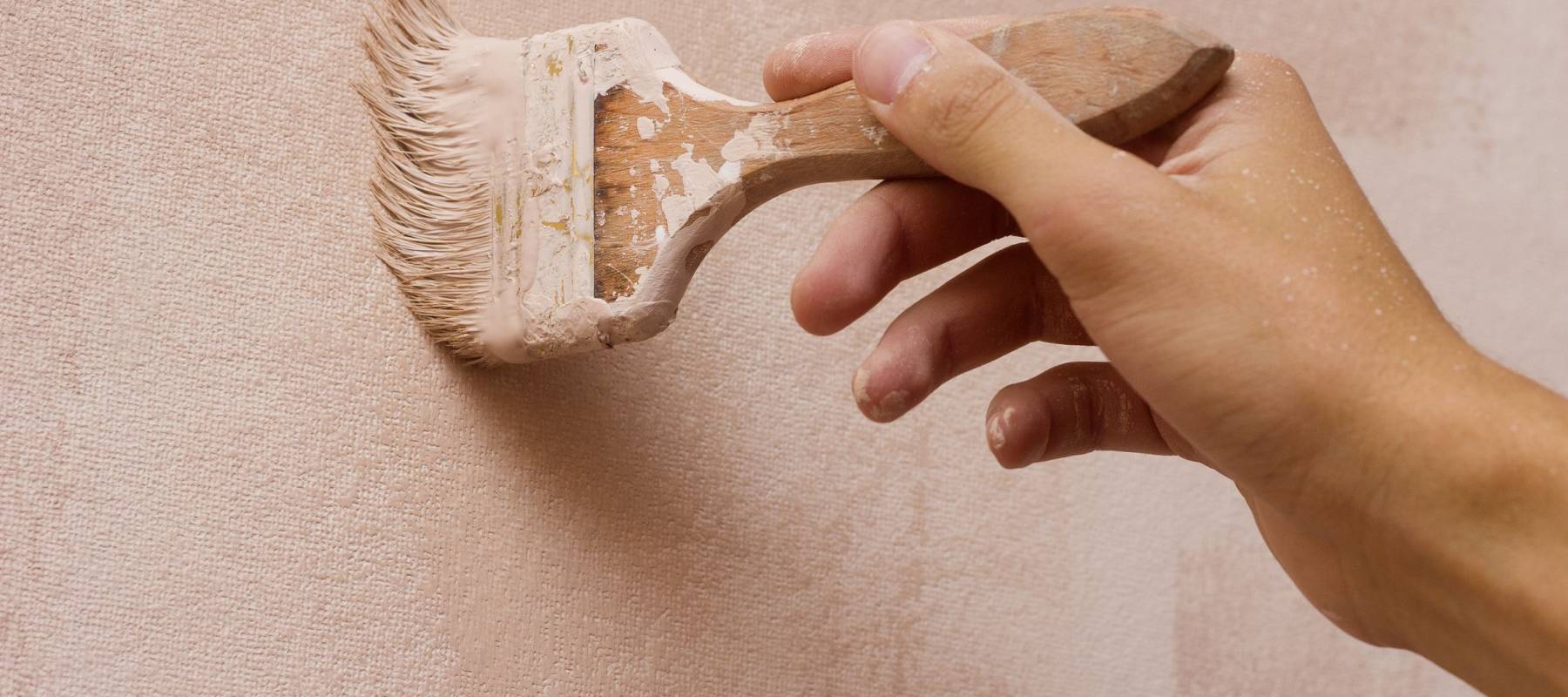 man decorating or painting with a paint brush