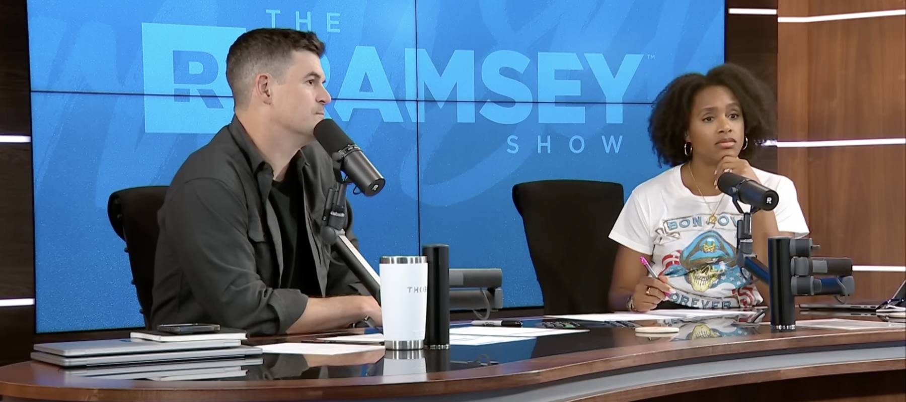 Ramsey Show co-hosts Jade Warshaw and John Delony look concerned on set