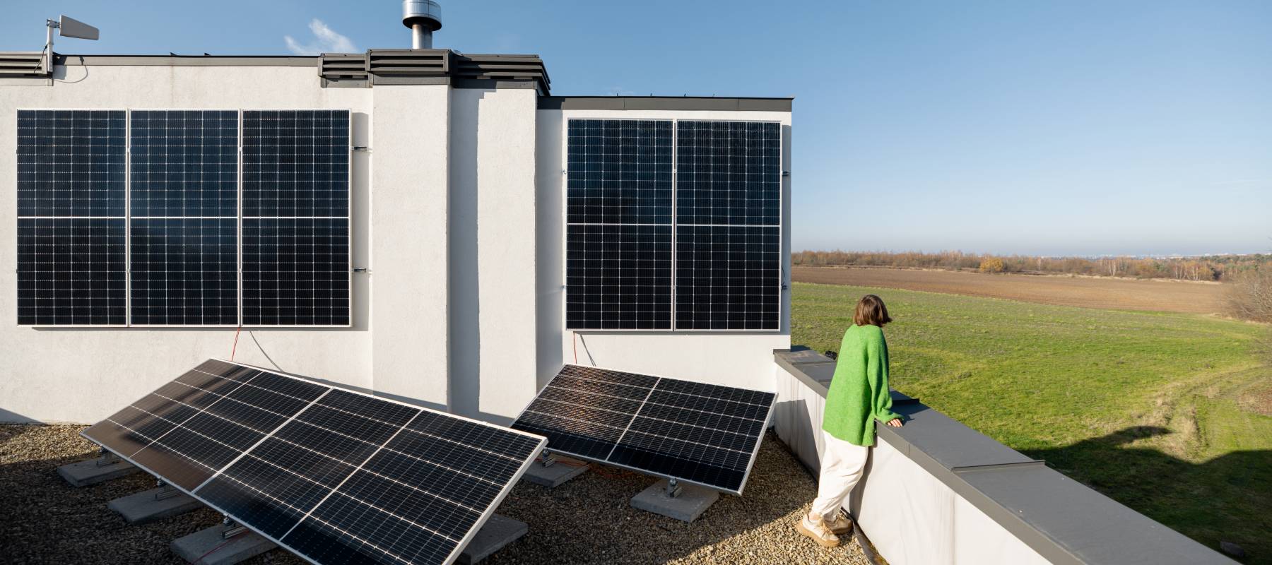 Aerial shot of a woman looking out from a rooftop, seemingly deep in thought.