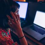 Woman looking concerned while staring at computer screen.