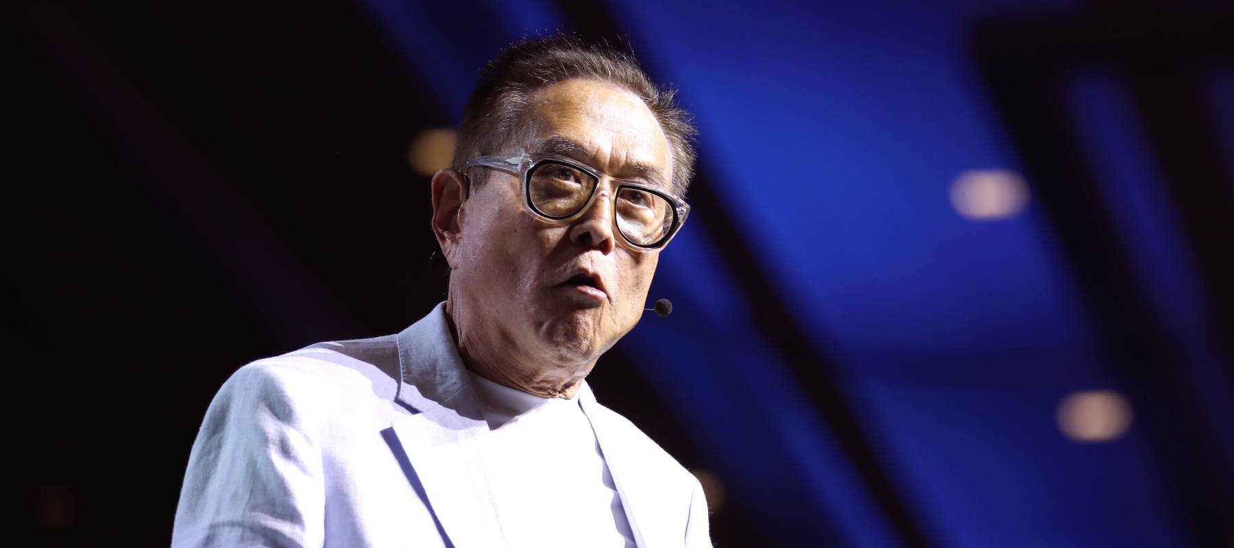 Robert Kiyosaki speaking with attendees at the 2024 FreedomFest at Caesars Forum Conference Center in Las Vegas, Nevada.