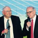 Warren Buffett watches Charlie Munger as he spills the secrets to financial success.