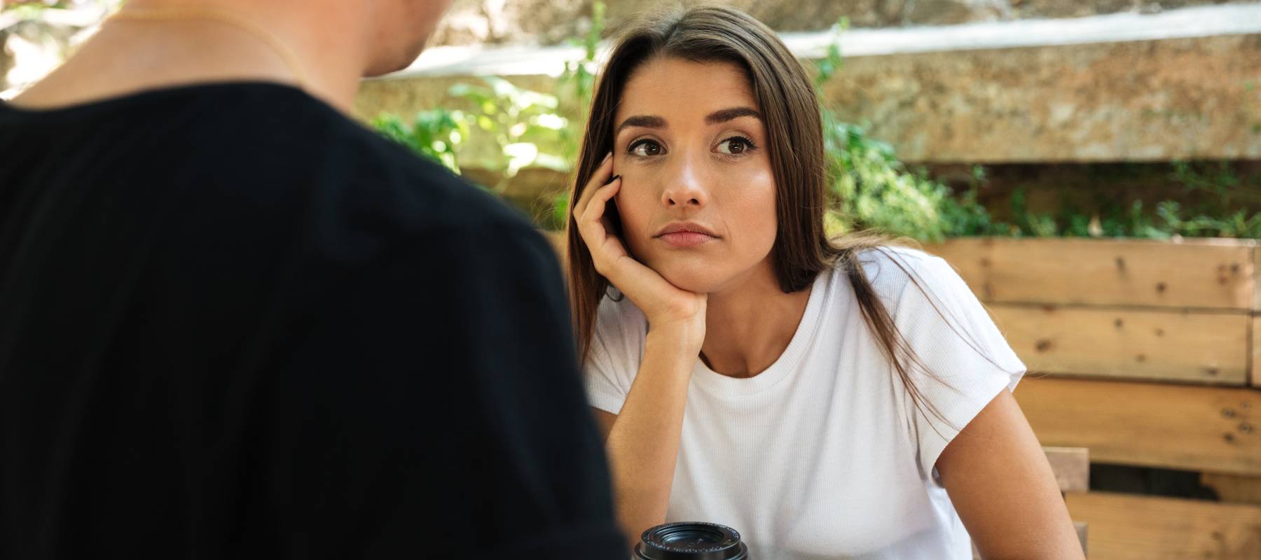 A young, bored woman on a coffee date.