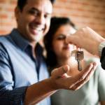 Cheerful couple with keys to their new home