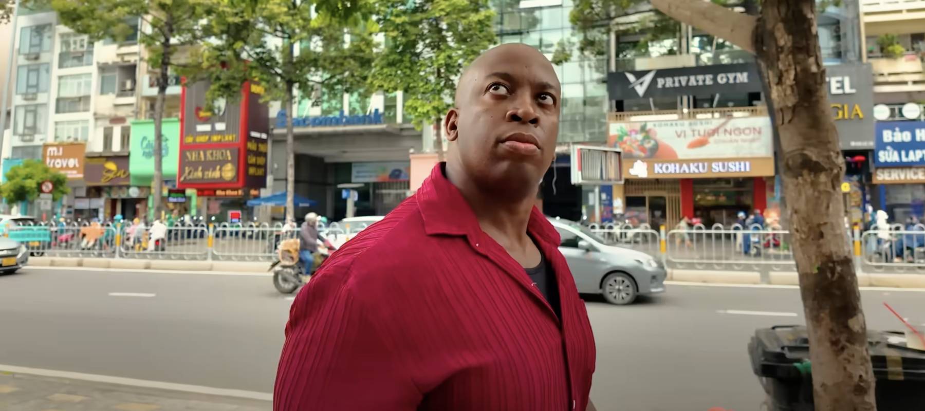 Markeiz Ryan stands on the street looking up in Vietnam