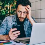 Worried bearded young man reading searching for information about his amended tax return