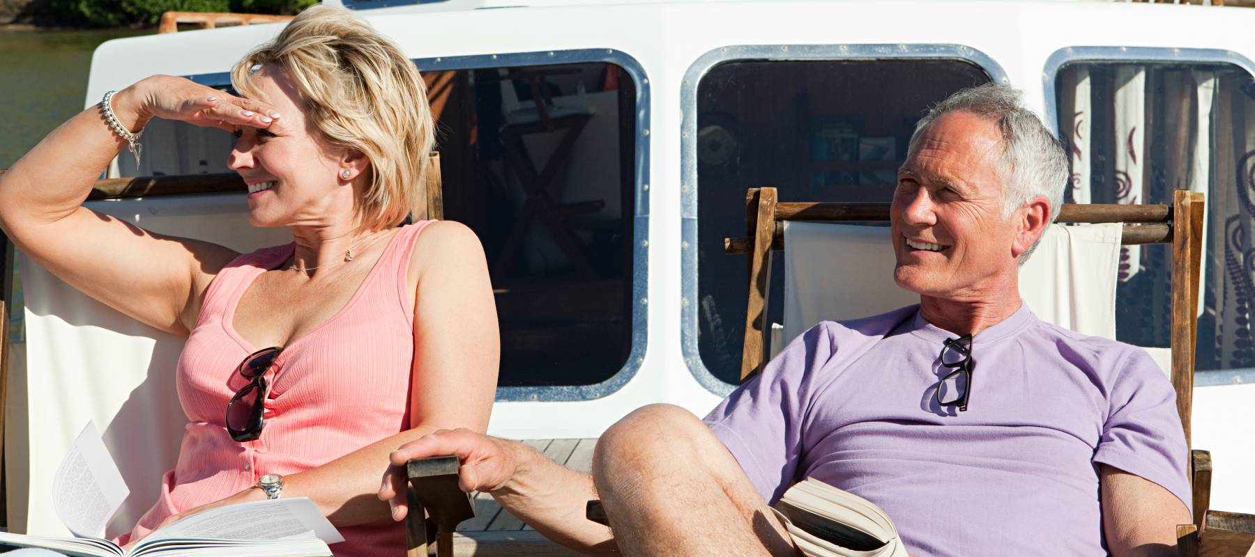 Senior couple on small boat looking at horizon
