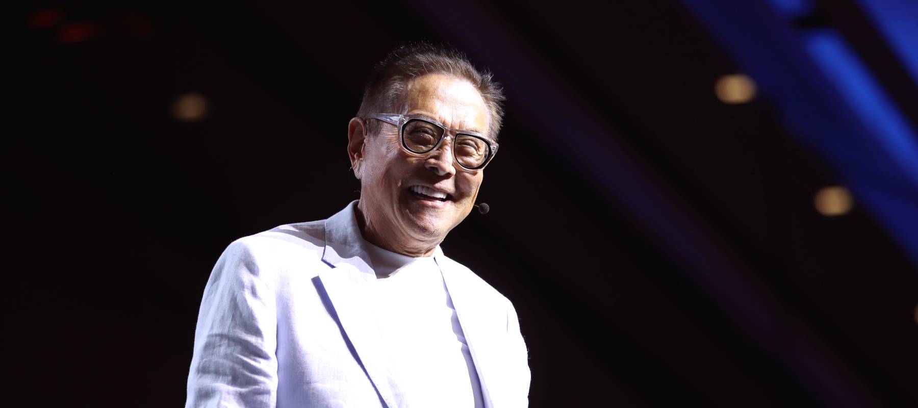 Robert Kiyosaki speaking with attendees at the 2024 FreedomFest at Caesars Forum Conference Center in Las Vegas, Nevada.