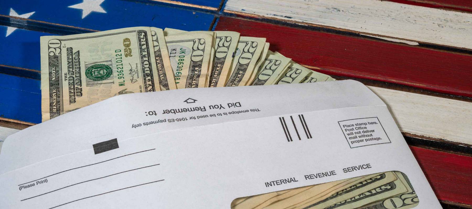 Stack of 20 dollar bills in IRS envelope to illustrate coronavirus stimulus payment or estimated tax payments