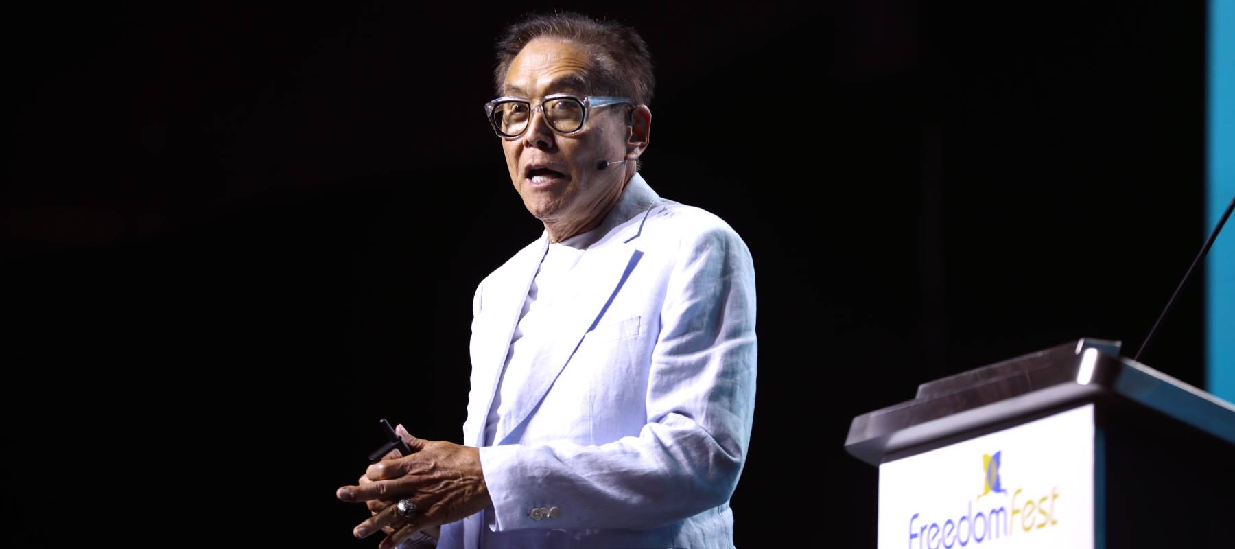 Robert Kiyosaki speaking with attendees at the 2024 FreedomFest at Caesars Forum Conference Center in Las Vegas, Nevada.