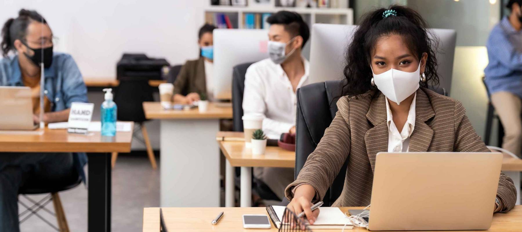 Portrait office workers wear face mask working in new normal office with social distance