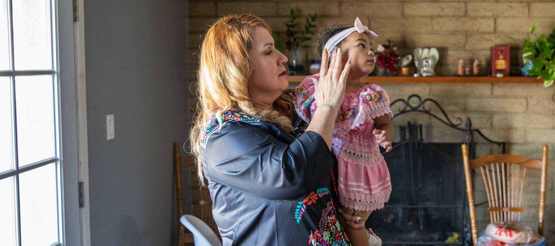 Woman tends to granddaughter because child care has become too expensive for her daughter.