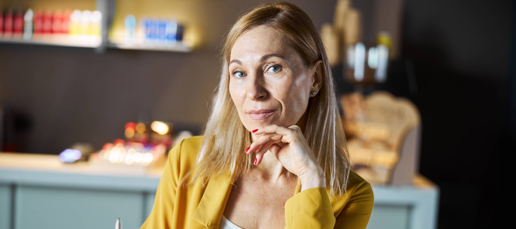 Blond woman looking directly at the camera pensively.