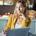 Blond woman looking directly at the camera pensively.