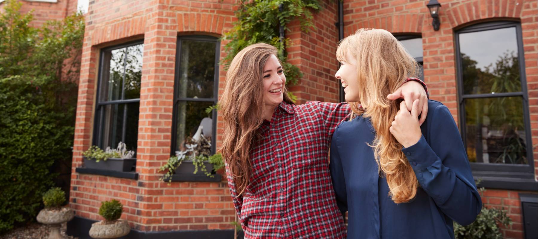 Women celebrating homeownership.