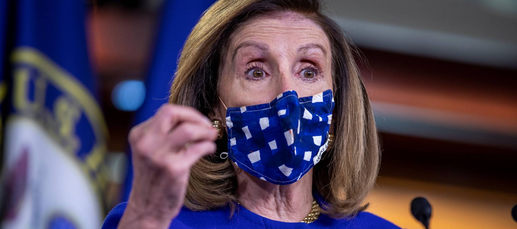 A masked Speaker of the House Nancy Pelosi delivers remarks during a news conference on Oct. 9, 2020.