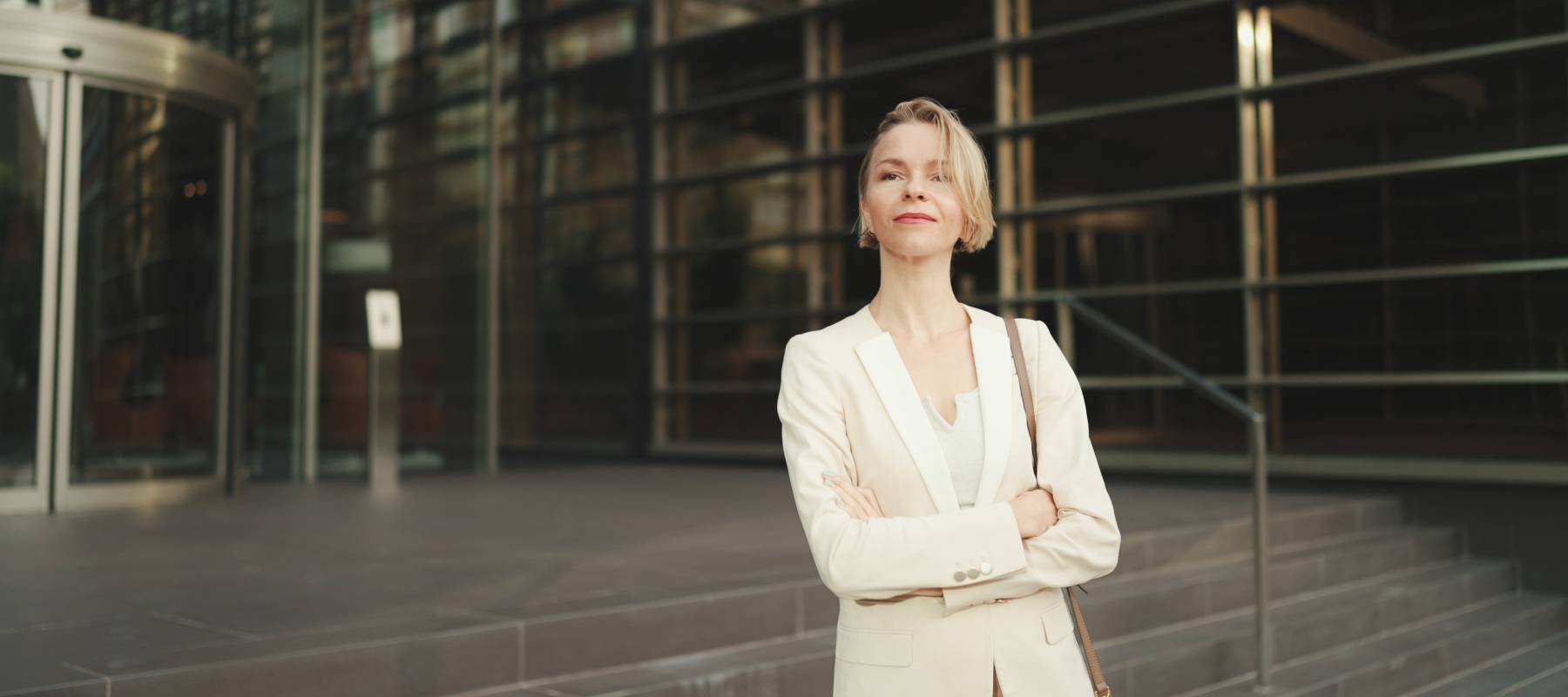 Caucasian businesswoman with blond hair wearing beige suit