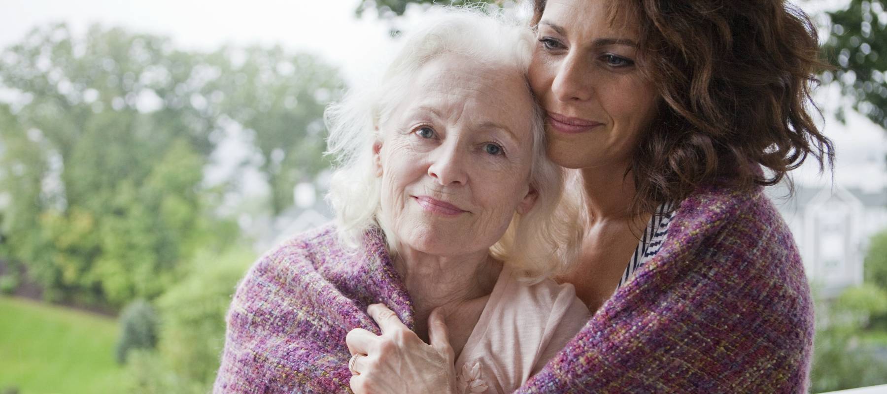 tender moment shared between two women on a balcony