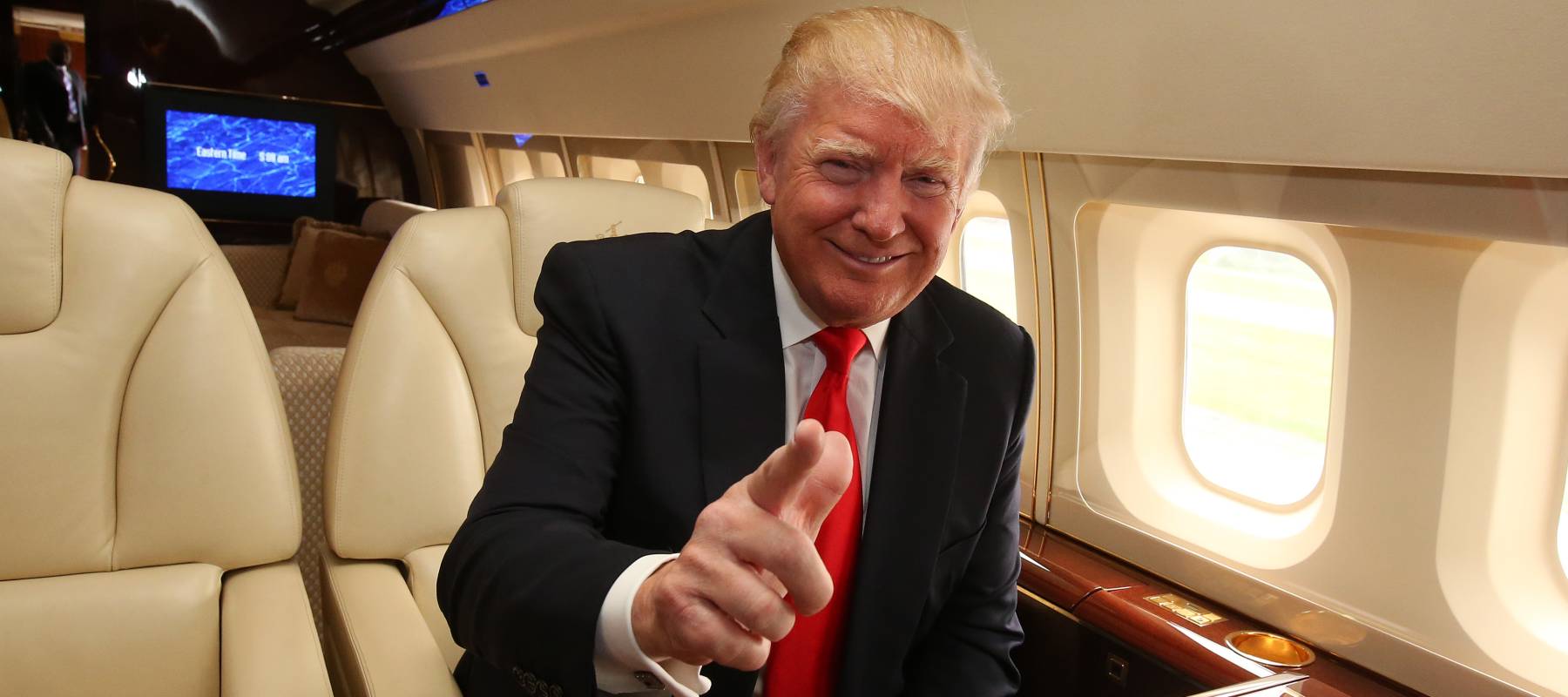American tycoon Donald Trump onboard his private jet, as he arrives at Aberdeen Airport in 2014.