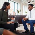 Female African-American hiring manager interviews African-American job candidate