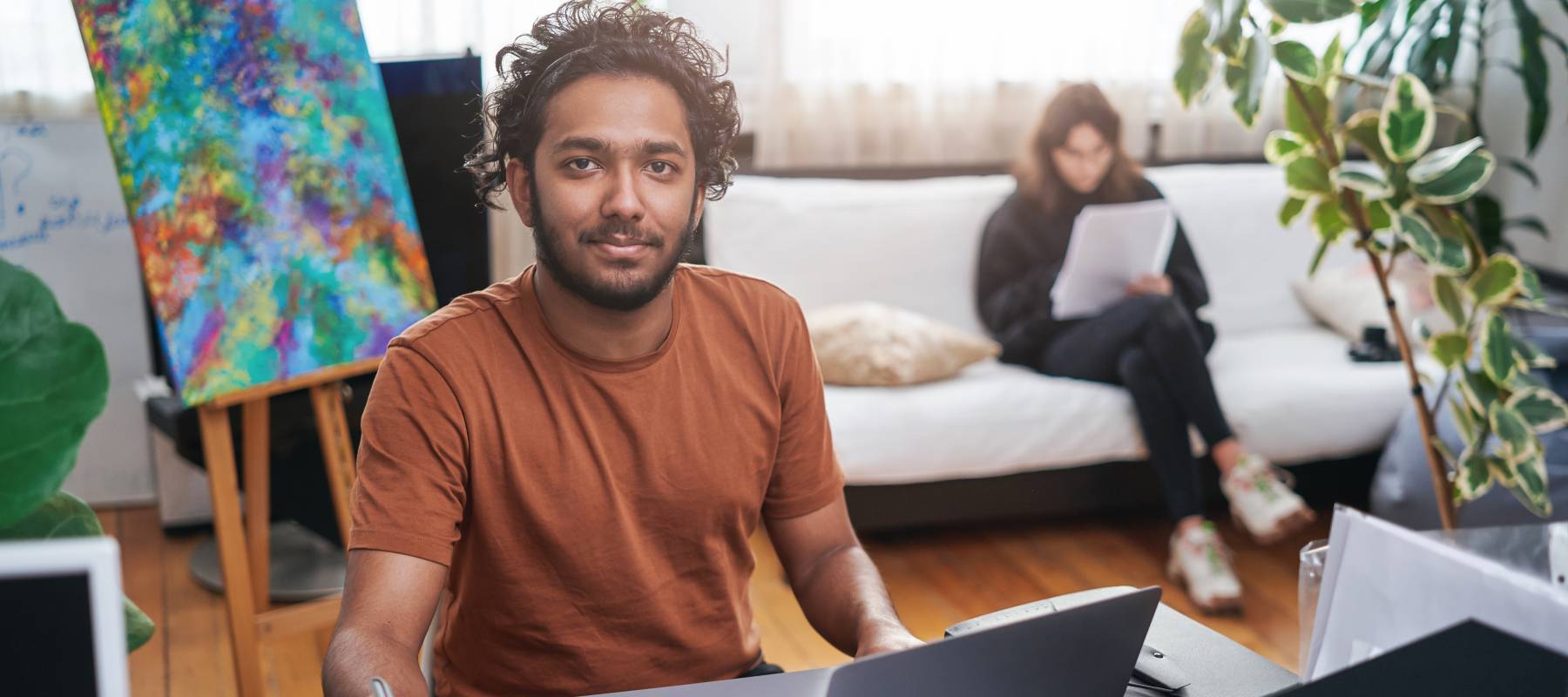Indian guy creates new business as designer in modern office room