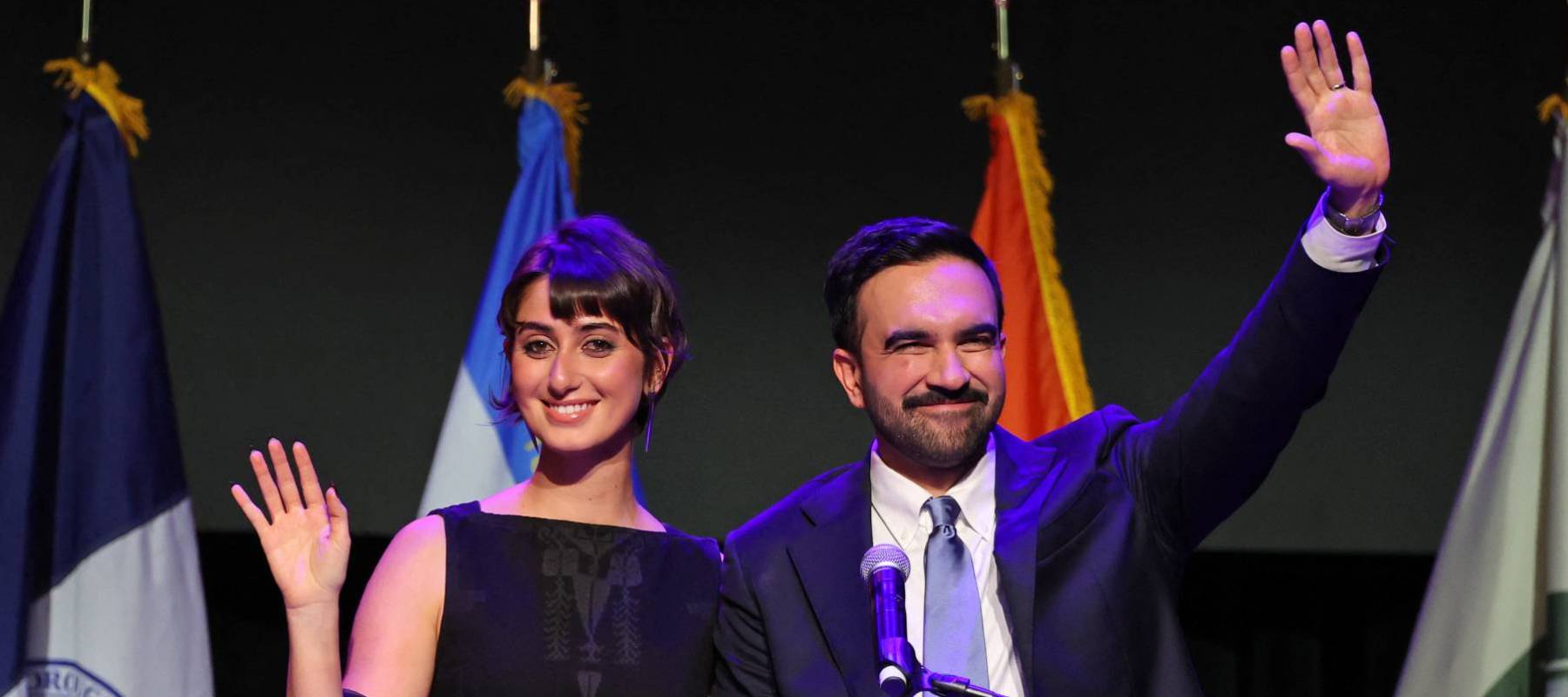 Newly minted New York City mayor Zohran Mamdani stands on stage with his wife, Rama Sawaf Duwaji, at an election night event at Brooklyn Paramount Theater in Brooklyn on November 4, 2025