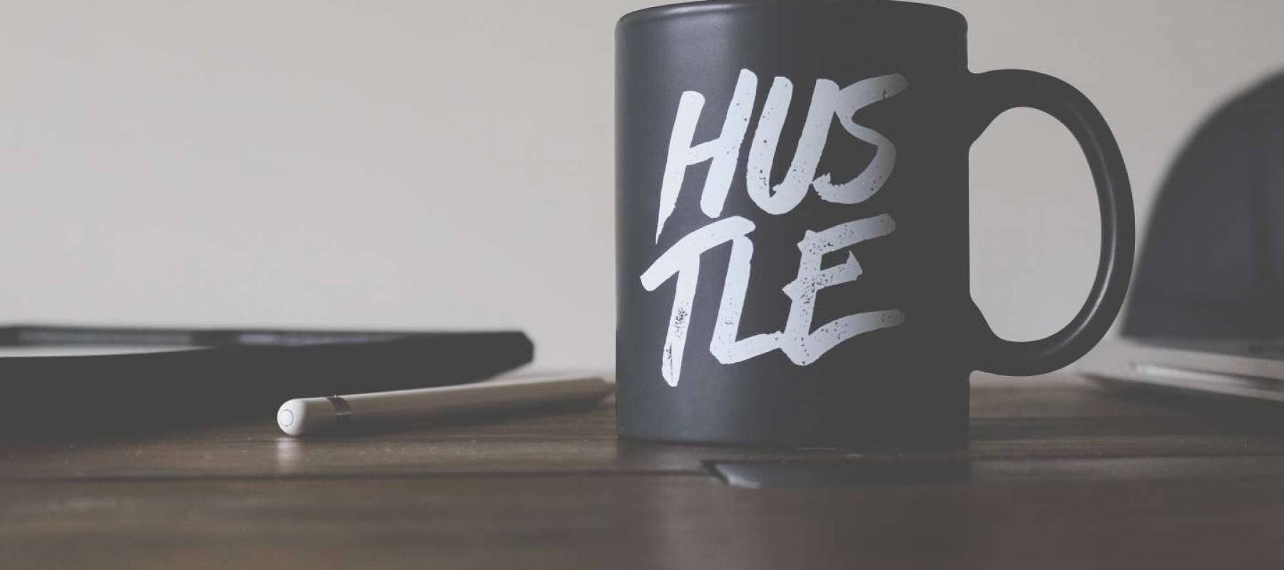 Coffee mug with &#039;Hustle&#039; on it