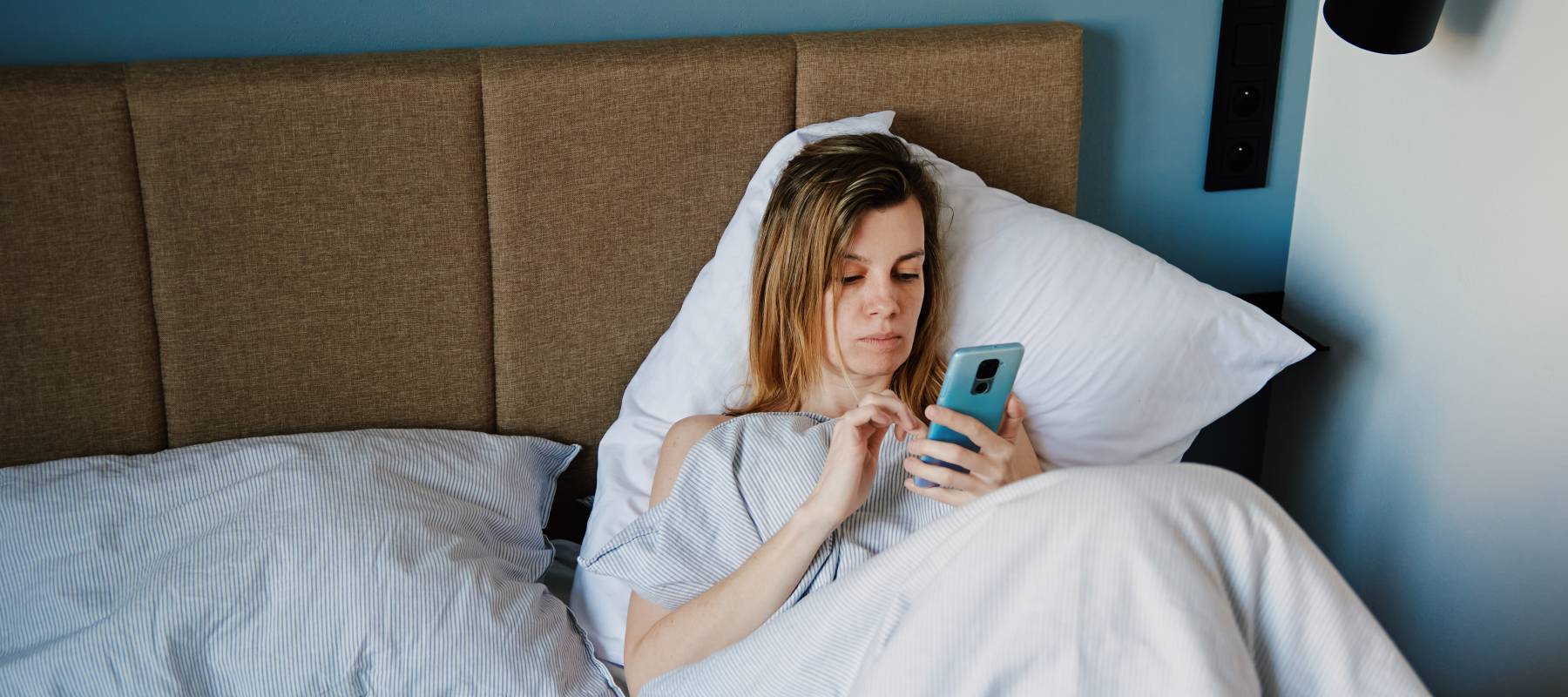 Woman using smartphone in the bed, Social media, Lazy weekend