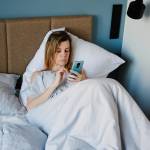 Woman using smartphone in the bed, Social media, Lazy weekend