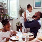 Father at the breakfast table with his two daughters