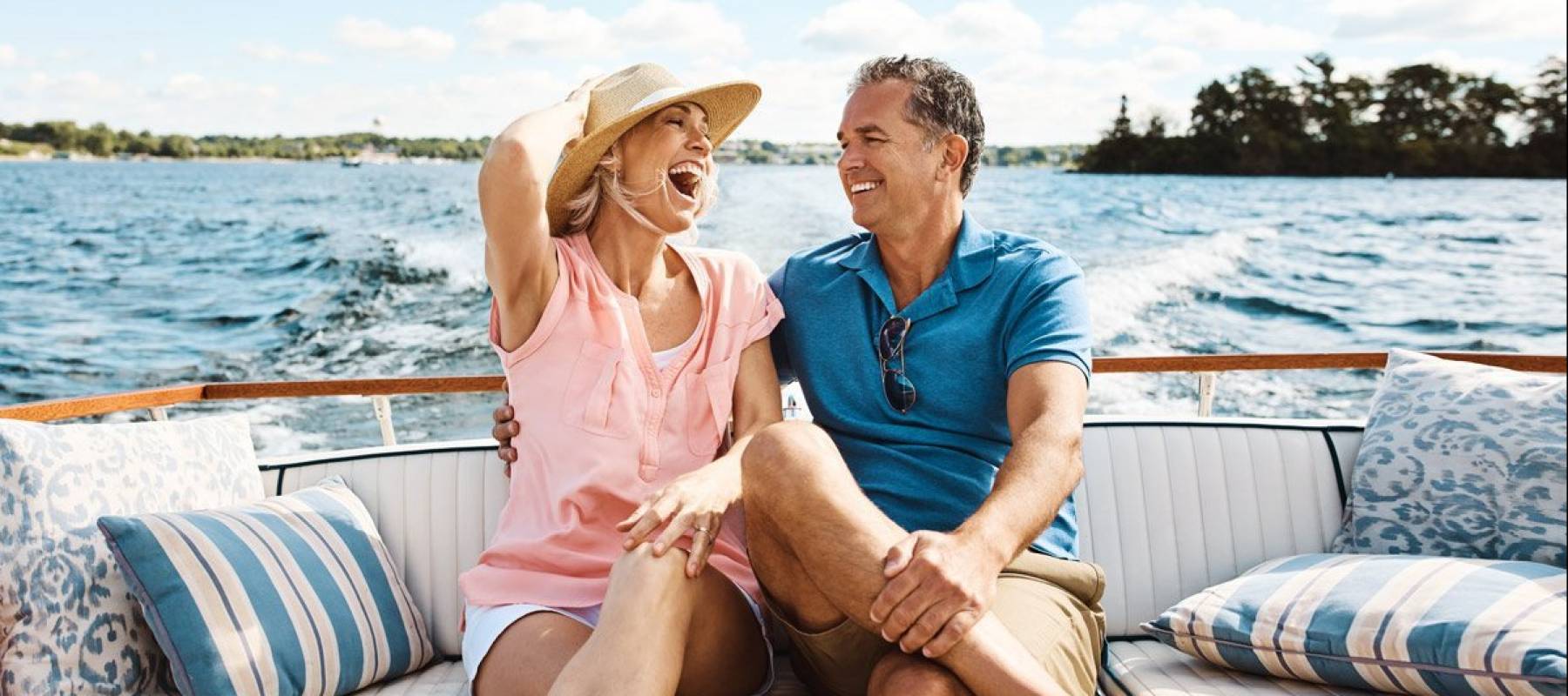 Older woman and man relaxing in the back of a pleasure boat