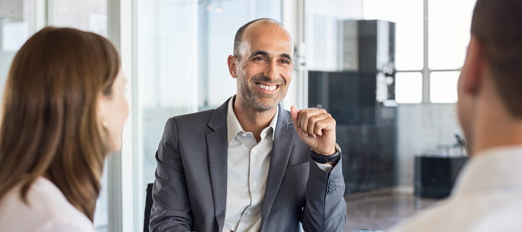 financial advisor meeting with couple in his office