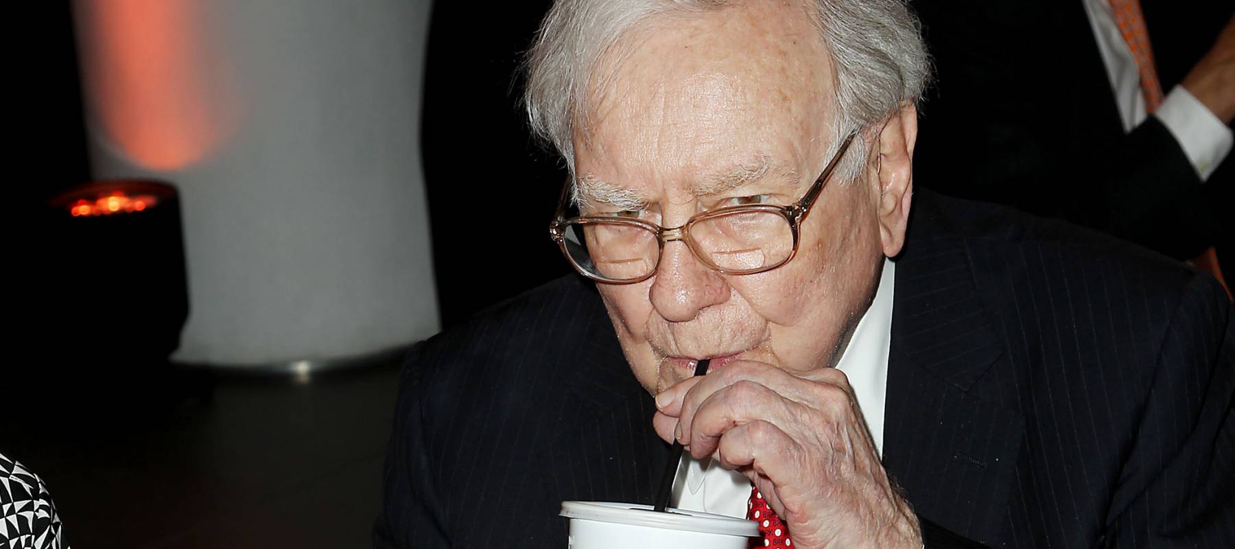 Warren Buffett sips drink