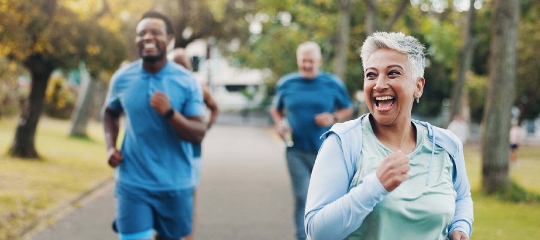 A group of runners lead my a woman.
