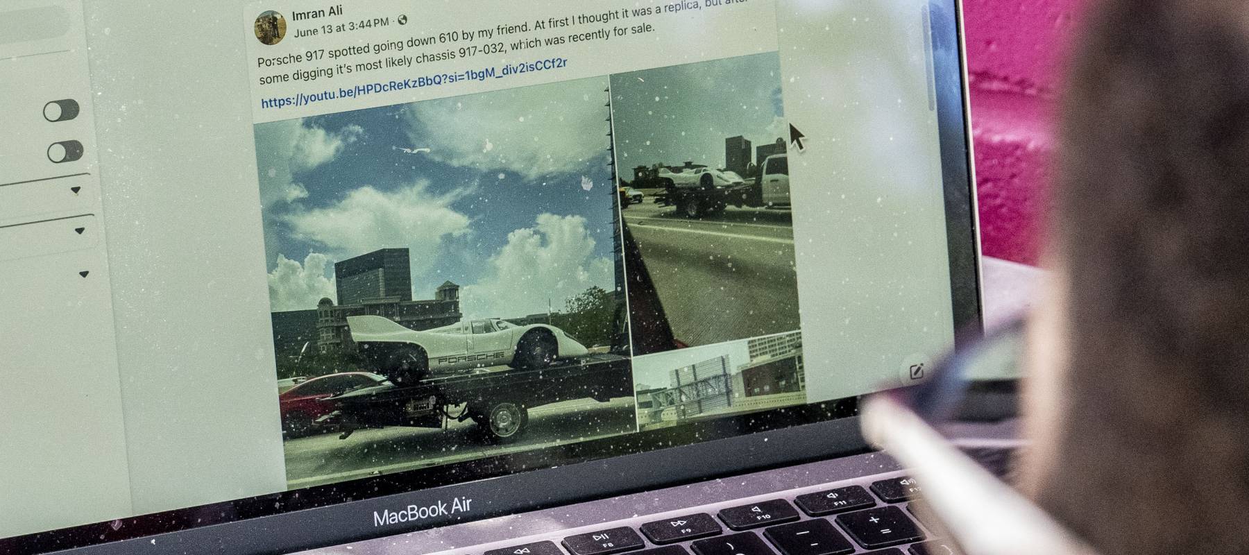 Close up of a person using Facebook on a Macbook looking at a post about cars.
