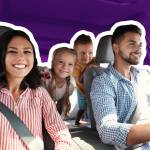 Smiling family sitting in a car on a road trip