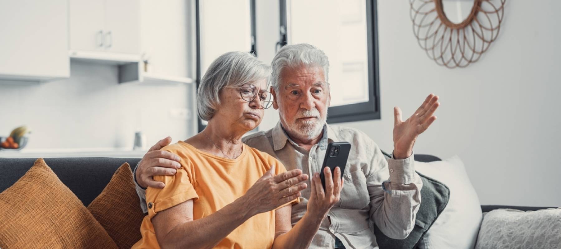 senior Caucasian couple looking stressed at home