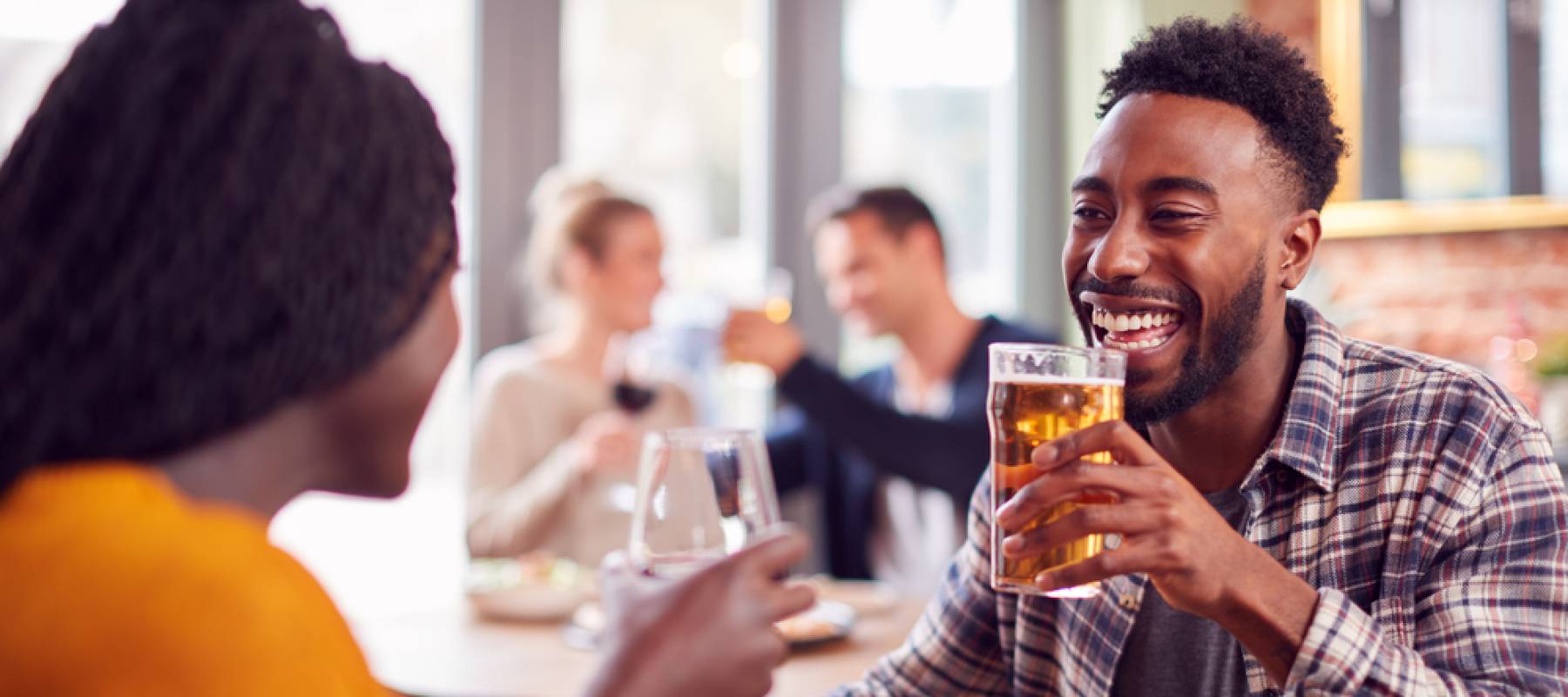 a young happy Black couple on a date in a restaurant