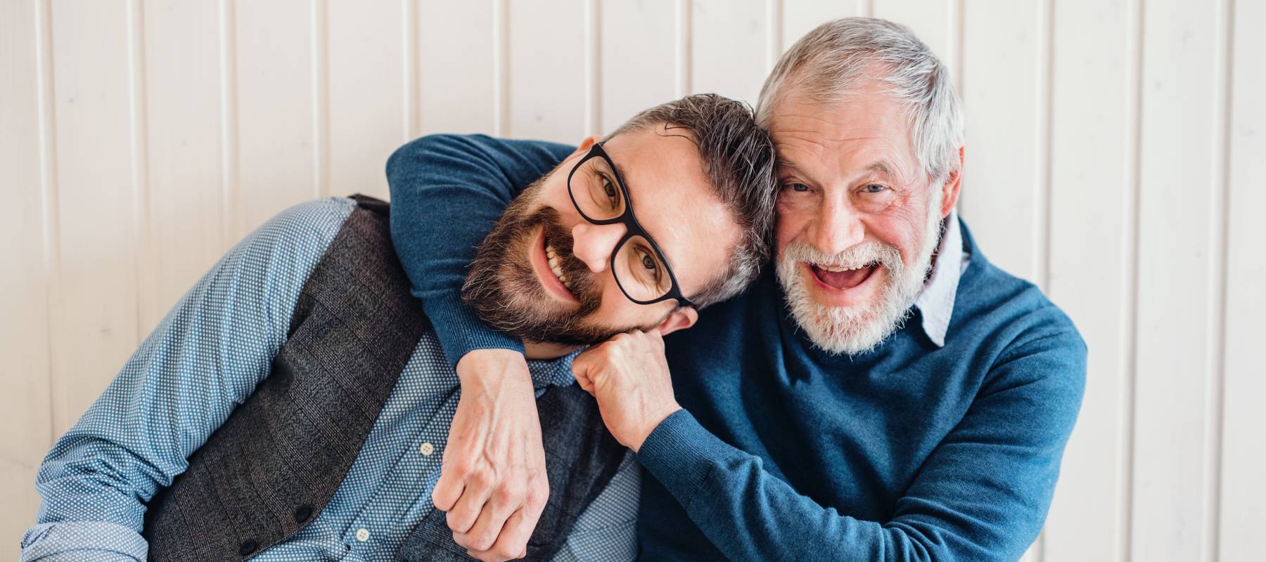 A portrait of adult hipster son and senior father